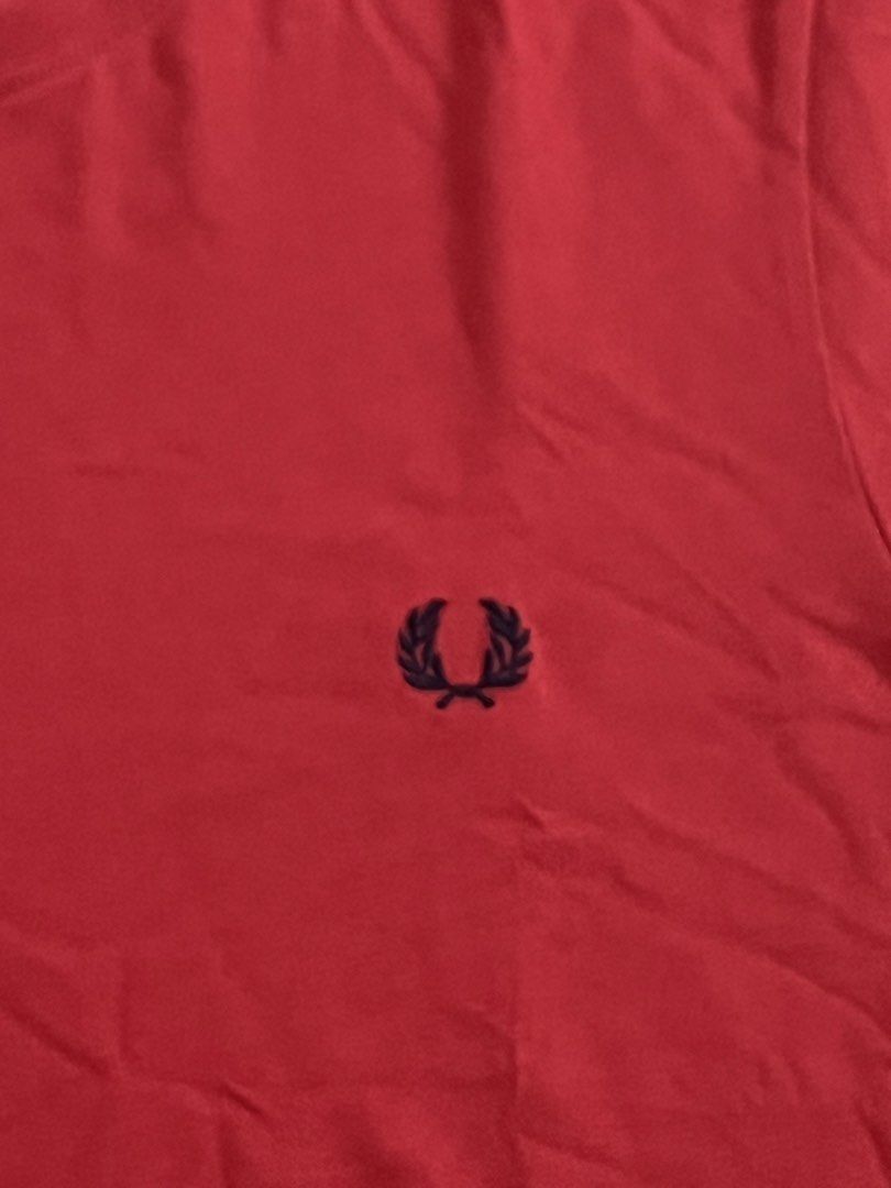 Fred Perry Red T-Shirt Size S (Category: Tshirts & Polo Shirts ) located in Victorias. Submitted by lan1877 (Listing ID 1465675465, Image 2). Description: - Brand: Fred Perry - Style/Model: M6334 - Size: Small - Color: Red with dark blue laurel wreath embroidery - Details: Contrast tipping on inner collar tape, clean cotton fabric, regular fit, straight hem - Condition: Excellent casual wear staple.