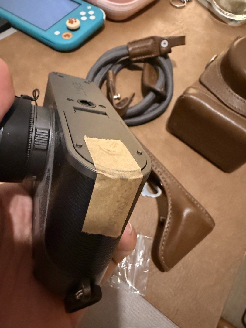 Fujifilm X Half Camera with SmallRig Brown Case and Strap (Category: Cameras) located in Mandaluyong City. Submitted by ohayouclub (Listing ID 1465698692, Image 3). Description: - Model: Fujifilm Xhalf Digital Camera - Color: Charcoal Black - Condition: Tested, fully working controls and dials (Note: broken battery cover, can be held by tape and case) - Inclusions: Matching SmallRig brown leather half case, full protective case, gray braided neck