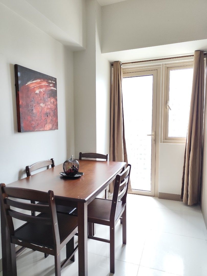 Fully Furnished Condo Unit for Rent (Category: Apartments & Condos) located in Pasay City. Submitted by nobleflower_5e9d64 (Listing ID 1465604529, Image 2). Description: - Ready to move in, clean, and well-maintained unit - Bright and airy with large windows for great natural light - Cozy living area and dining table with 4 chairs - Kitchen area equipped with an induction cooker and refrigerator - Separate bedroom featuring a comfortable double b