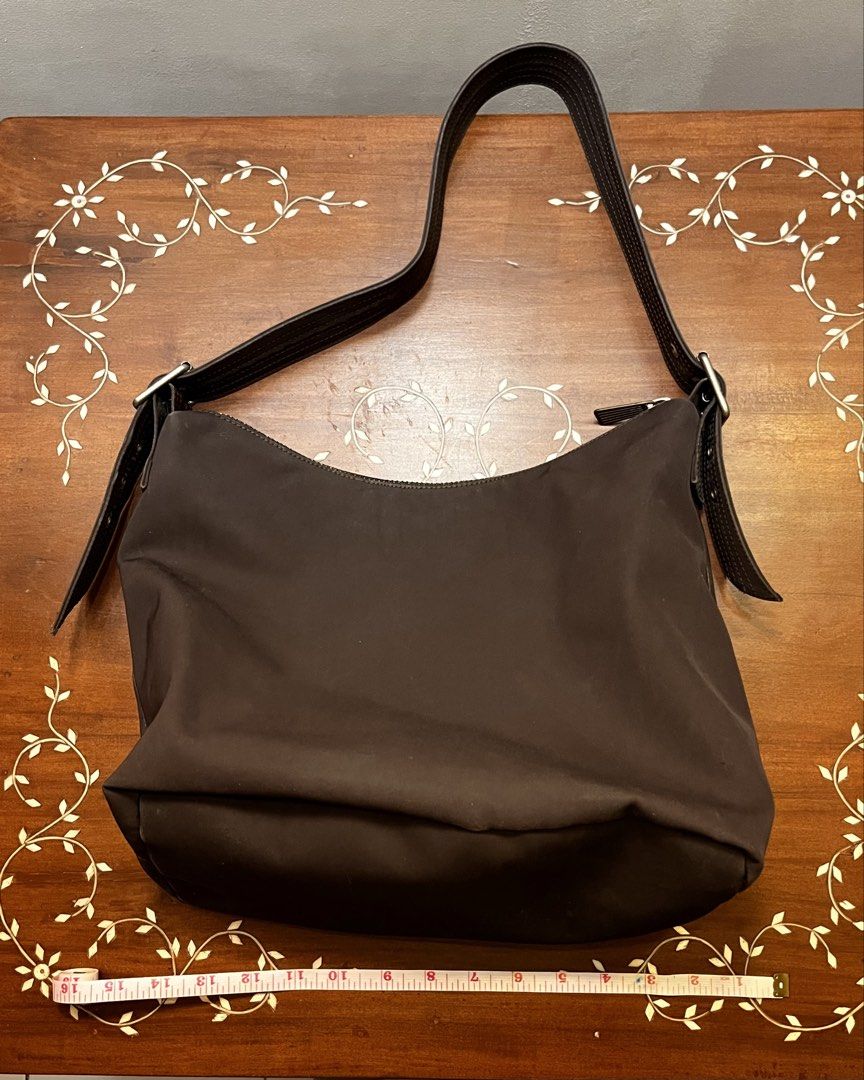Gap Brown Hobo Nylon Bag (Category: Shoulder Bags) located in Manila. Submitted by lalalens._ (Listing ID 1465677259, Image 2). Description: fixed + SF !! stylish hobo nylon bag with adjustable strap and zipper enclosure. very spacious interior, great for everyday wear! just not my style (see last pic for try-on).