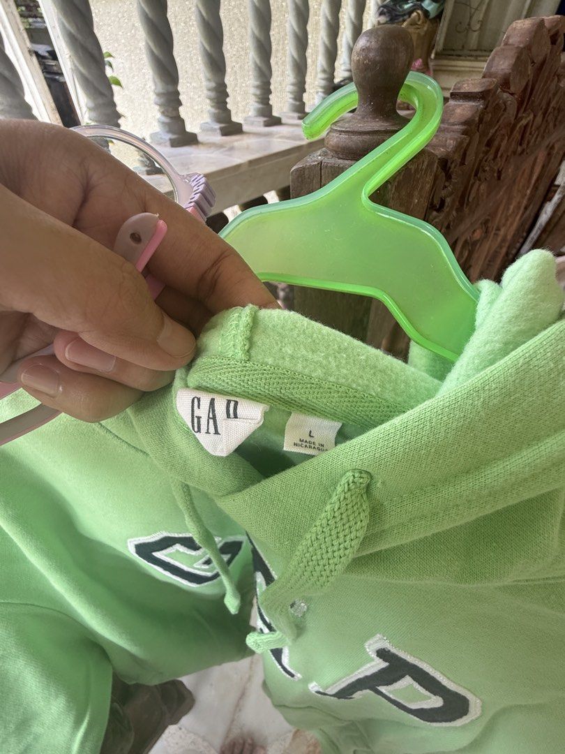 GAP Green Hoodie Size L (Category: Coats, Jackets and Outerwear) located in Manila. Submitted by angelaiza52734 (Listing ID 1465597248, Image 2). Description: - Brand: GAP - Color: Bright green with embroidered block logo - Size: L (Made in Nicaragua) - Style: Pullover with adjustable drawstring hood and kangaroo pocket - Material: Soft fleece interior with good ribbed cuffs and hem.