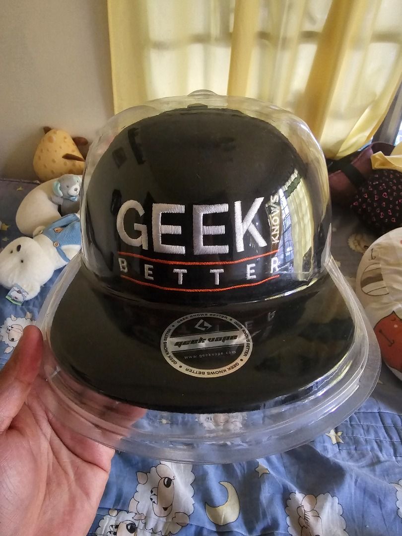 Geek Better snapback cap with plastic storage case (Category: Caps & Hats) located in Caloocan City. Submitted by chawnn (Listing ID 1465647430, Image 2). Description: - Color: Classic black with contrasting white 'GEEK BETTER' embroidery - Details: Eye-catching orange accent stitching on the brim and flat brim design with original brand sticker - Fit: Adjustable snap closure at the back for a custom fit - Bonus: Includes a clear protective dome 