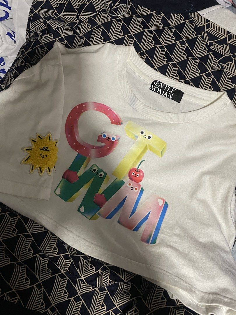 Gentle Woman Croptop Tee (Category: Shirts) located in Taguig. Submitted by 1989tswizzle (Listing ID 1465758347, Image 1). Description: - Brand: Gentle Woman (Authentic from Thailand) - Style: Cropped tee / Short sleeve - Size: Free size - Color: White with colorful graphic print and yellow sun sleeve patch - Condition: Preloved, rated 5/10 (please manage expectations).