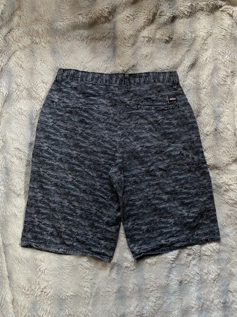 Genuine Dickies Camo Pattern Cargo Shorts Grey Black (Category: Shorts) located in Andop. Submitted by safewater-895a (Listing ID 1465677850, Image 1). Description: - Brand: Genuine Dickies - Design: Dark grey and black camouflage pattern - Closure: Classic button closure with zipper fly and belt loops - Pockets: Dual back pockets with secure button closures - Details: Signature Dickies woven logo tag on back right pocket - Style: Durable utility