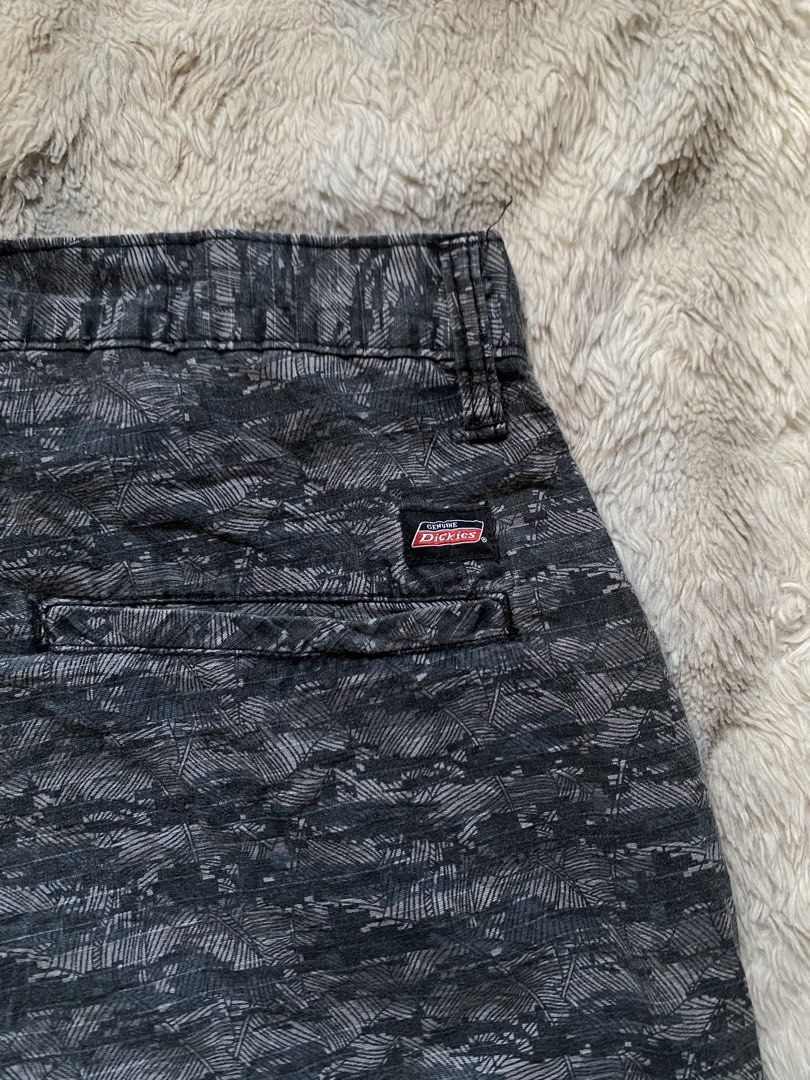 Genuine Dickies Camo Pattern Cargo Shorts Grey Black (Category: Shorts) located in Andop. Submitted by safewater-895a (Listing ID 1465677850, Image 3). Description: - Brand: Genuine Dickies - Design: Dark grey and black camouflage pattern - Closure: Classic button closure with zipper fly and belt loops - Pockets: Dual back pockets with secure button closures - Details: Signature Dickies woven logo tag on back right pocket - Style: Durable utility