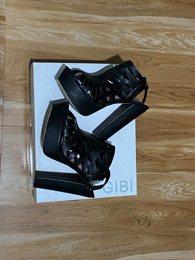 Gibi Mitsuri Black Strappy High Heel Sandals (Category: Heels) located in Oas. Submitted by noblehorse.394f5b (Listing ID 1465579650, Image 3). Description: - Brand: Gibi - Color: Classic Black - Style: Strappy cage-cutout heels with open toe - Heel Type: Stable chunky block heel with a comfortable platform sole - Closure: Adjustable buckle ankle strap - Inclusions: Comes with original box - Condition: Excellent / Like new.