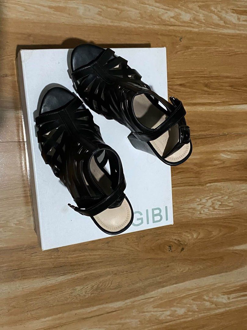 Gibi Mitsuri Black Strappy High Heel Sandals (Category: Heels) located in Oas. Submitted by noblehorse.394f5b (Listing ID 1465579650, Image 2). Description: - Brand: Gibi - Color: Classic Black - Style: Strappy cage-cutout heels with open toe - Heel Type: Stable chunky block heel with a comfortable platform sole - Closure: Adjustable buckle ankle strap - Inclusions: Comes with original box - Condition: Excellent / Like new.