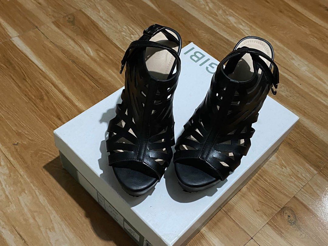 Gibi Mitsuri Black Strappy High Heel Sandals (Category: Heels) located in Oas. Submitted by noblehorse.394f5b (Listing ID 1465579650, Image 1). Description: - Brand: Gibi - Color: Classic Black - Style: Strappy cage-cutout heels with open toe - Heel Type: Stable chunky block heel with a comfortable platform sole - Closure: Adjustable buckle ankle strap - Inclusions: Comes with original box - Condition: Excellent / Like new.