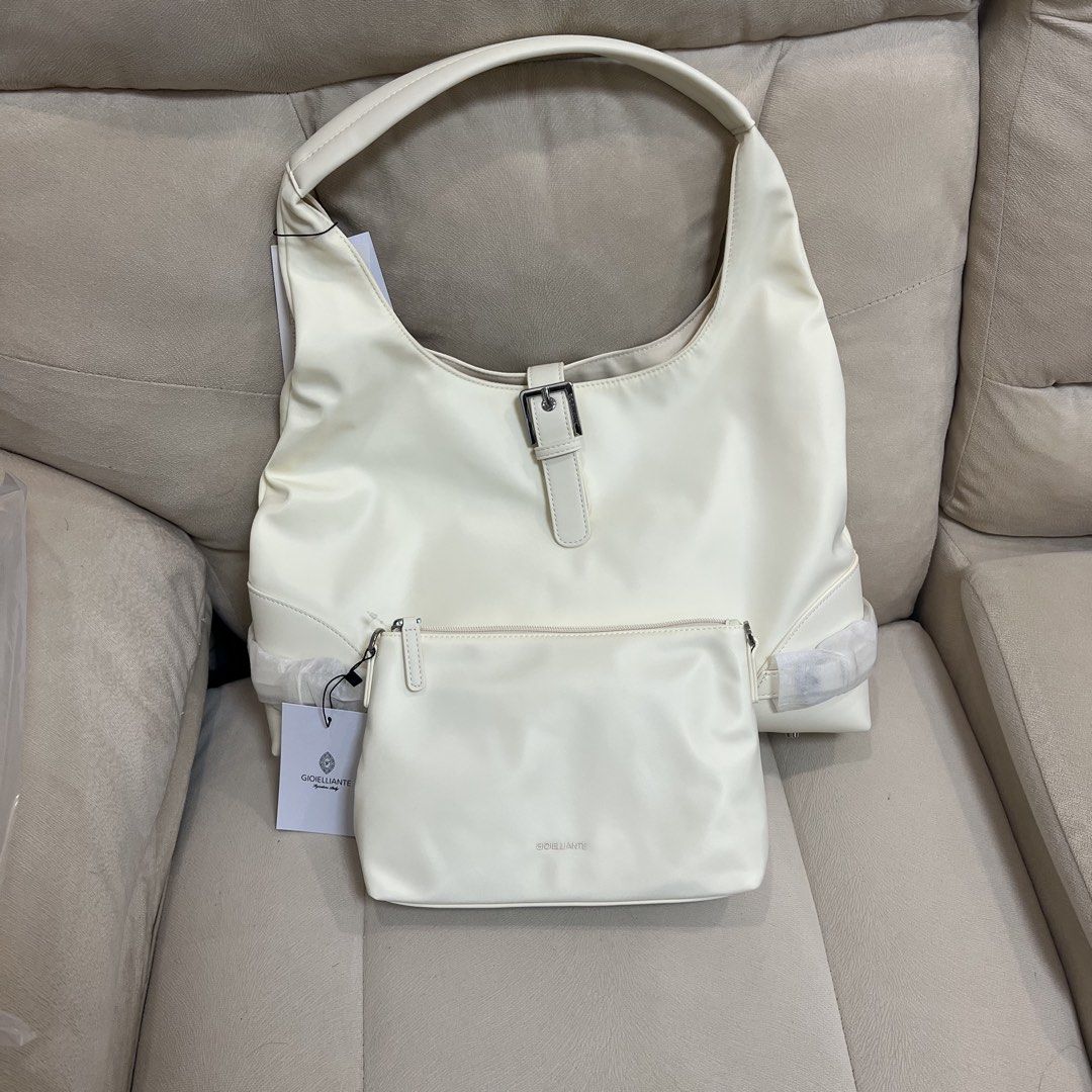 Gioielliante Off-White Shoulder Bag with Pouch (Category: Shoulder Bags) located in Manila. Submitted by pau_only (Listing ID 1465674862, Image 1). Description: - Brand: Gioielliante - Color: Clean off-white - Material: Smooth finish - Inclusions: Matching small zipped pouch - Features: Silver front buckle accent, outer zipper pocket on the back - Condition: Brand new with tag attached, protective wrapping still on hardware and bottom corners.