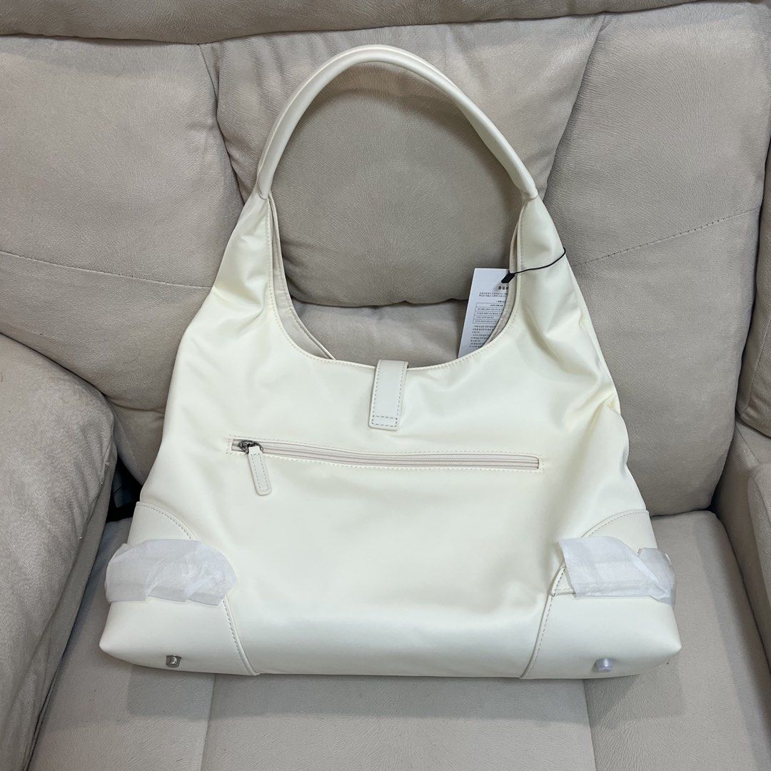 Gioielliante Off-White Shoulder Bag with Pouch (Category: Shoulder Bags) located in Manila. Submitted by pau_only (Listing ID 1465674862, Image 2). Description: - Brand: Gioielliante - Color: Clean off-white - Material: Smooth finish - Inclusions: Matching small zipped pouch - Features: Silver front buckle accent, outer zipper pocket on the back - Condition: Brand new with tag attached, protective wrapping still on hardware and bottom corners.