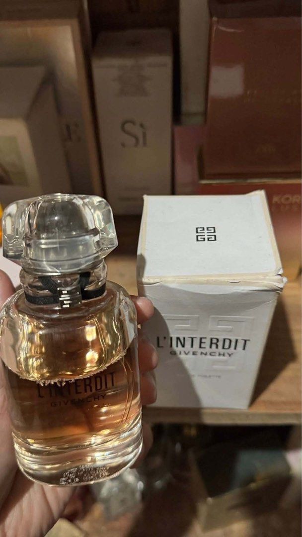 Givenchy L'Interdit Eau de Toilette with Box (Category: Fragrance & Deodorants) located in Quezon City. Submitted by mhyloves21 (Listing ID 1465592633, Image 1). Description: - Authentic Givenchy L'Interdit perfume bottle(bought in SM Dept Store) - Warm, amber-colored fragrance inside a sleek glass design - Adorned with the iconic black ribbon and transparent geometric cap - Includes original white cardboard box (note: minor creasing and wear alo