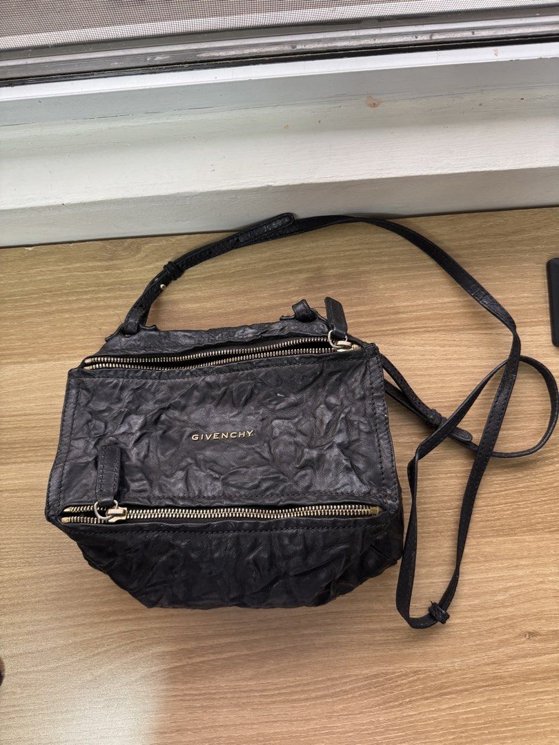 Givenchy Pandora Bag (Crossbody) Black (Category: Luxury Bags & Wallets) located in Manila. Submitted by prinsloo_ (Listing ID 1465662809, Image 1). Description: - Brand: Givenchy - Material: Black crinkled leather with subtle texture - Hardware: Gold-tone accents - Closure: Secure zip closures on front and top - Strap: Long and adjustable for comfortable wear - Pockets: Convenient exterior slip pocket on the back - Style: Slouchy, edgy, and perf
