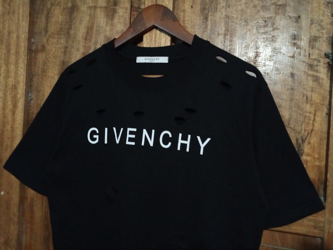Givenchy Paris Distressed Logo T-Shirt Black (Category: Activewear) located in Boston. Submitted by johnpaulvi30029 (Listing ID 1465692481, Image 2). Description: - Brand: Givenchy Paris - Color: Black with white chest logo - Style: Short sleeve crew neck t-shirt - Details: Intentional distressed rips and cutouts around the collar and lower hem for a streetwear edge - Condition: Clean, well-maintained - Deal: Ready to ship or meet up in Metro Man