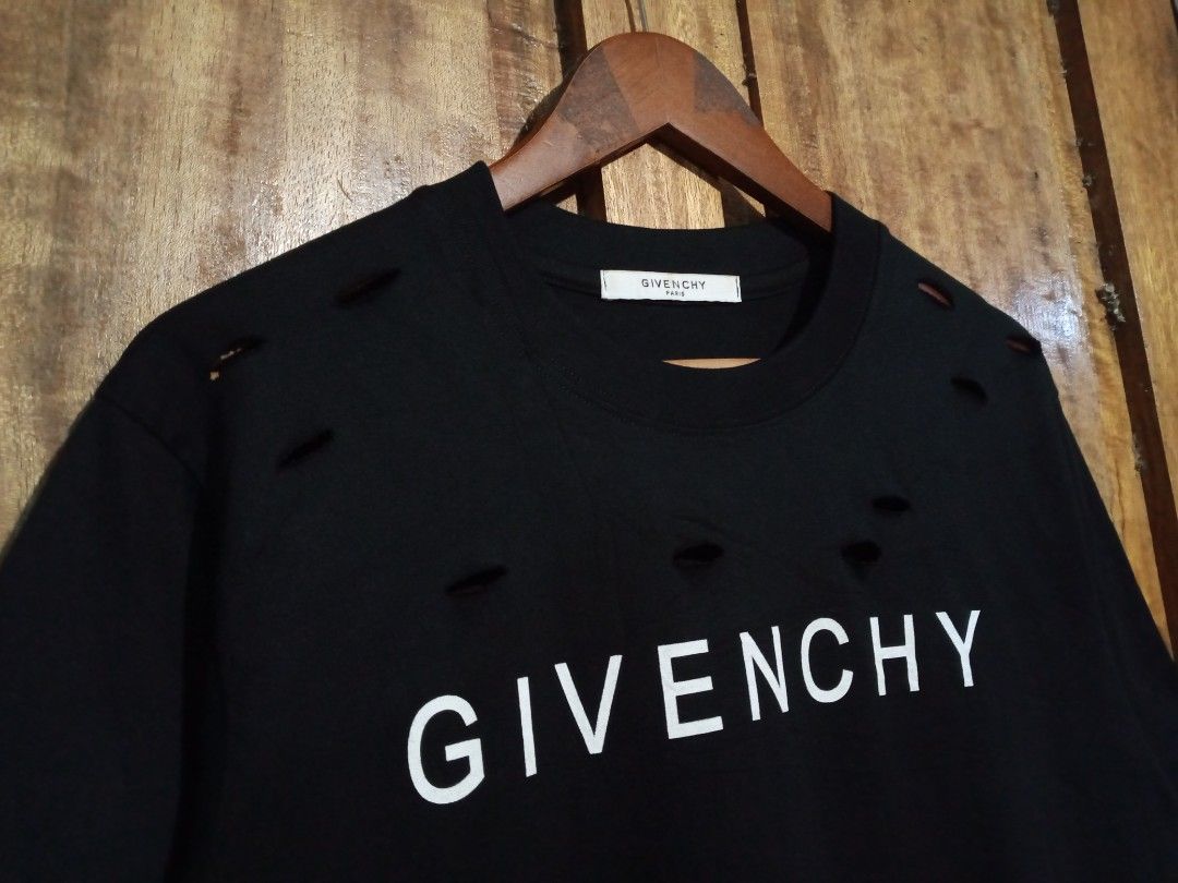 Givenchy Paris Distressed Logo T-Shirt Black (Category: Activewear) located in Boston. Submitted by johnpaulvi30029 (Listing ID 1465692481, Image 3). Description: - Brand: Givenchy Paris - Color: Black with white chest logo - Style: Short sleeve crew neck t-shirt - Details: Intentional distressed rips and cutouts around the collar and lower hem for a streetwear edge - Condition: Clean, well-maintained - Deal: Ready to ship or meet up in Metro Man