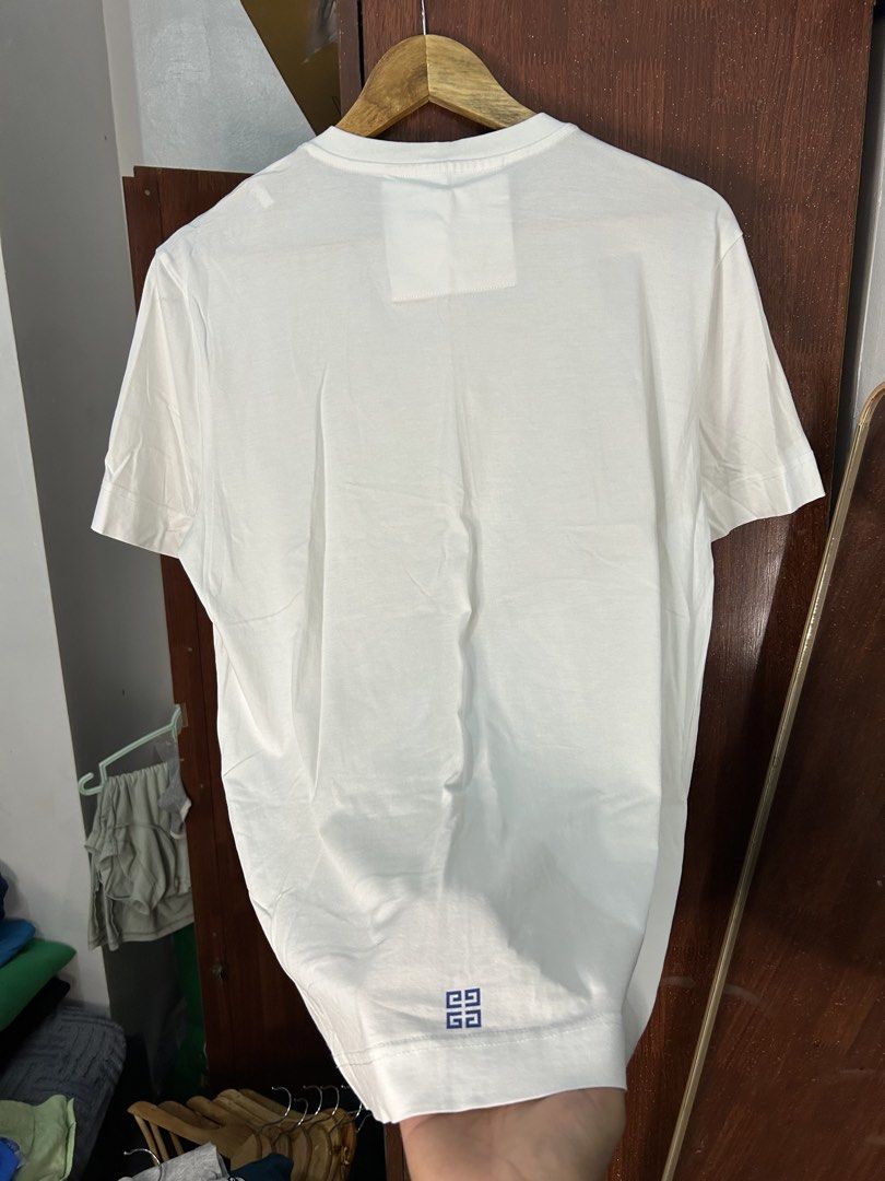 Givenchy Paris Wave Graphic White T-Shirt Size M (Category: Tshirts & Polo Shirts ) located in Davao. Submitted by ruggedthrift444 (Listing ID 1465687233, Image 2). Description: - Brand: Givenchy Paris - Size: M - Color: Clean White - Design: Colorful wave graphic inside a textured circular frame on the front - Details: Small branding print near the bottom hem on the back - Material: 100% premium cotton - Fit: Classic crew neckline with short sle