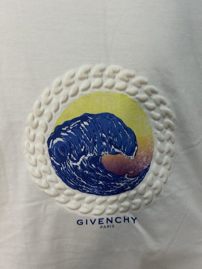 Givenchy Paris Wave Graphic White T-Shirt Size M (Category: Tshirts & Polo Shirts ) located in Davao. Submitted by ruggedthrift444 (Listing ID 1465687233, Image 3). Description: - Brand: Givenchy Paris - Size: M - Color: Clean White - Design: Colorful wave graphic inside a textured circular frame on the front - Details: Small branding print near the bottom hem on the back - Material: 100% premium cotton - Fit: Classic crew neckline with short sle