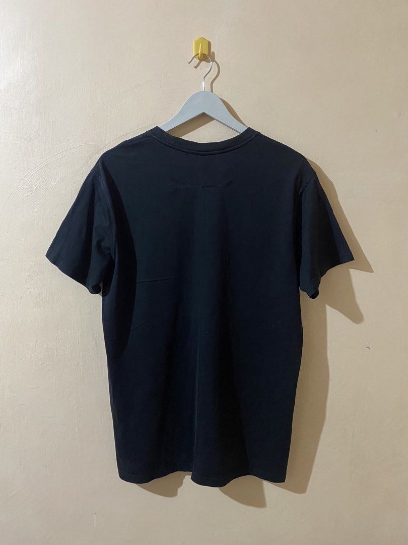 Givenchy Star Logo T-Shirt (Category: Tshirts & Polo Shirts ) located in Naga. Submitted by trashfinds (Listing ID 1465598123, Image 2). Description: Designed under the creative direction of Riccardo Tisci, this classic streetwear piece features a minimalist, embroidered or printed white star outline on the left chest of a black crewneck cotton shirt. Details of the item: Size: M on tag Length: 29” Width: 21” Color rate: 9/10 Issue: pinhole not n