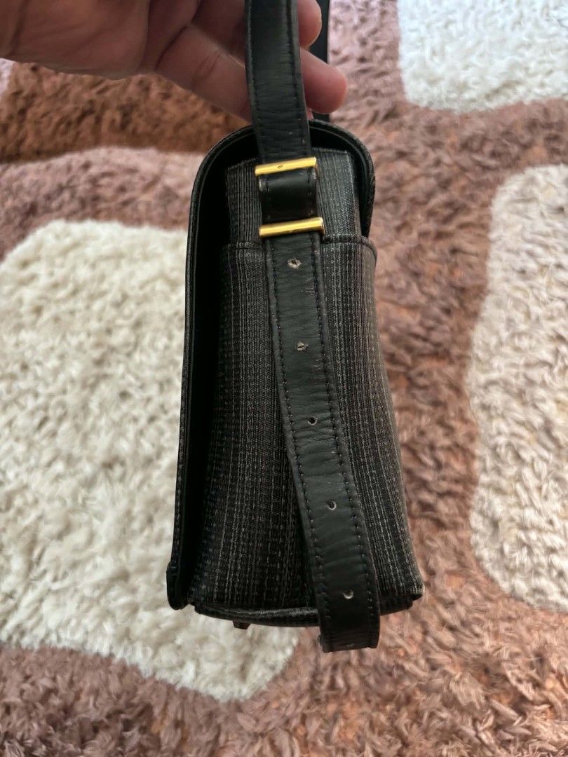 Givenchy vintage grey textured messenger shoulder bag (Category: Luxury Bags & Wallets) located in Daet. Submitted by jemotovlog28 (Listing ID 1465749396, Image 2). Description: Givenchy messenger bag in grey textured fabric and black leather trim. Flap closure with gold tone hardware and the classic Givenchy logo plate on the front. Adjustable black leather strap with gold hardware details. Deep main compartment inside. Minor wear visible on the