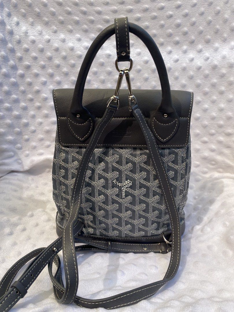 Goyard Alpin Mini Backpack Grey (Category: Backpacks) located in Tanay. Submitted by judevalcorza (Listing ID 1465588645, Image 2). Description: - Goyard Alpin Mini Backpack in timeless grey - Iconic chevron canvas with premium leather trim and embossed Goyard Paris stamp - Convertible multi-way design: adjustable straps hook onto the top ring for backpack, shoulder, or crossbody wear - Secure top flap with buckle closure and inner drawstring top