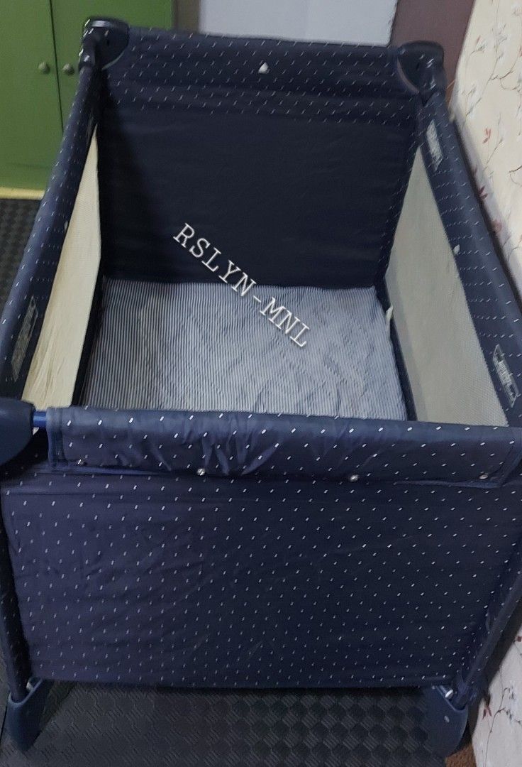 Graco Pack 'n Play Playard (Category: Cots & Cribs) located in Taguig. Submitted by thrifthub.ph (Listing ID 1465669176, Image 3). Description: - Brand: Graco Pack 'n Play - Design: Navy blue with cute white polka dots - Breathable mesh sides for safety and easy monitoring - Includes a comfy removable mattress pad - Sturdy frame equipped with wheels on one side for effortless portability - Folds down compactly for convenient travel and storage - 