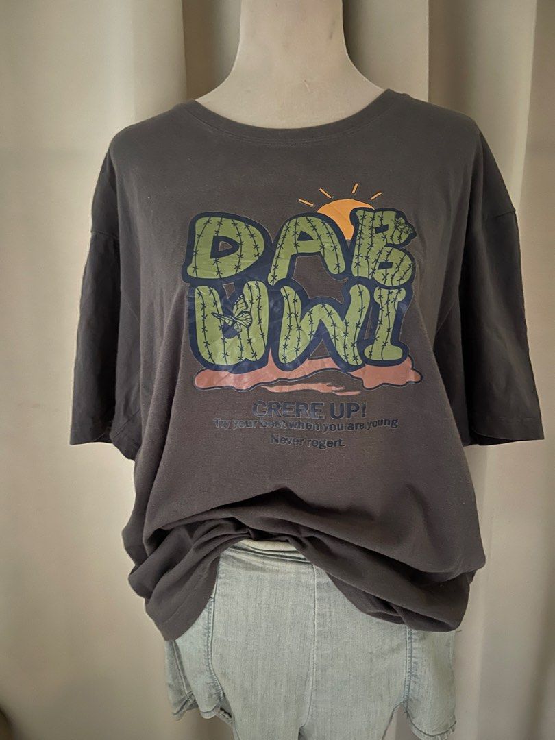 Graphic Cactus Oversized (Category: Shirts) located in Cainta. Submitted by zlove111 (Listing ID 1465758168, Image 2). Description: - Color: Dark grey - Design: Front cactus graphic with 'CRERE UP! Try your best when you are young Never regret.' text - Fit: Relaxed fit with a classic crew neck - Style: Short sleeve, easy to pair with denim shorts or jeans - Occasion: Perfect for casual everyday wear 23".
