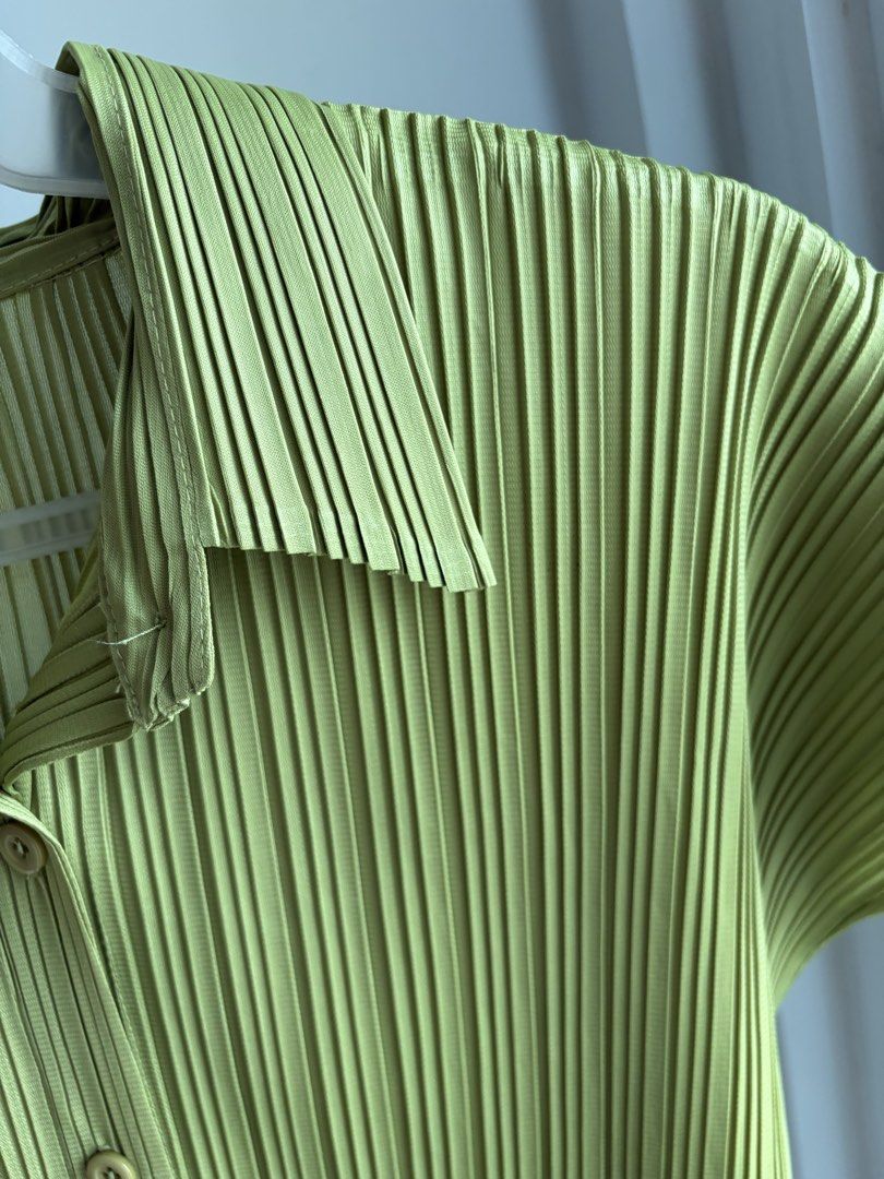 Green Pleated Short Sleeve Button-Down Top (Category: Blouses) located in Paranaque City. Submitted by mary_jj (Listing ID 1465652621, Image 2). Description: - fits xs-m (vv stretchy) - In the cutest matcha color. giving issey miyake .