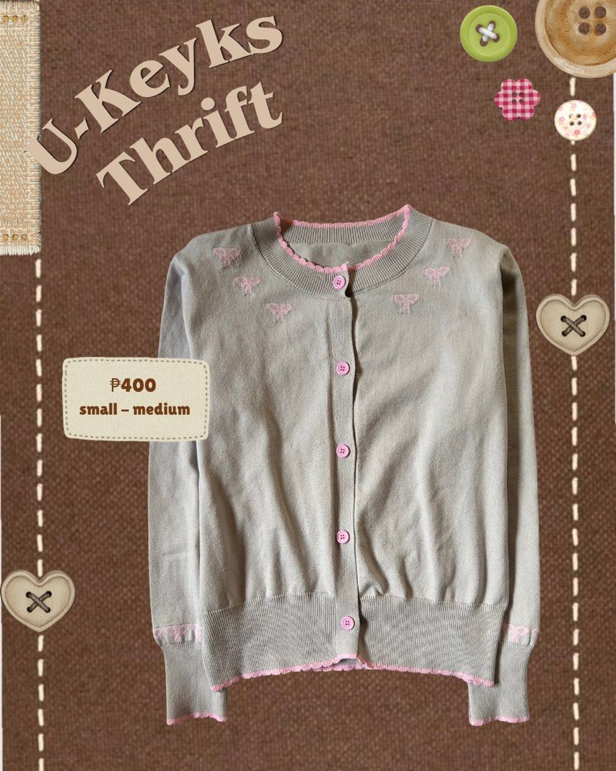 Grey Coquette Cardigan with Pink Bows Small-Medium (Category: Coats, Jackets and Outerwear) located in Cavite. Submitted by ukeyks (Listing ID 1465698556, Image 1). Description: - Color & Design: Grey knit cardigan with pink trim along the collar, hem, and cuffs - Details: Sweet embroidered pink bow patterns near the neckline and lower sleeves - Closure: Front button closure with matching pink buttons - Fit: Cropped style with ribbed cuffs and bo