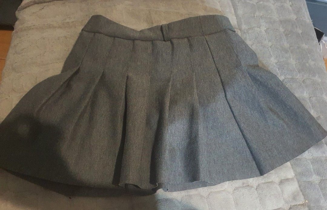 Grey pleated tennis mini skirt (Category: Skirts) located in Manila. Submitted by sabbyy_wabbyy (Listing ID 1465705472, Image 2). Description: - Color: Versatile solid grey - Style: Flared accordion pleats with structured waistband and belt loops - Fit: Mid-rise mini length - Closure: Easy side or back zip - Perfect for: Casual everyday outfits or school uniforms.