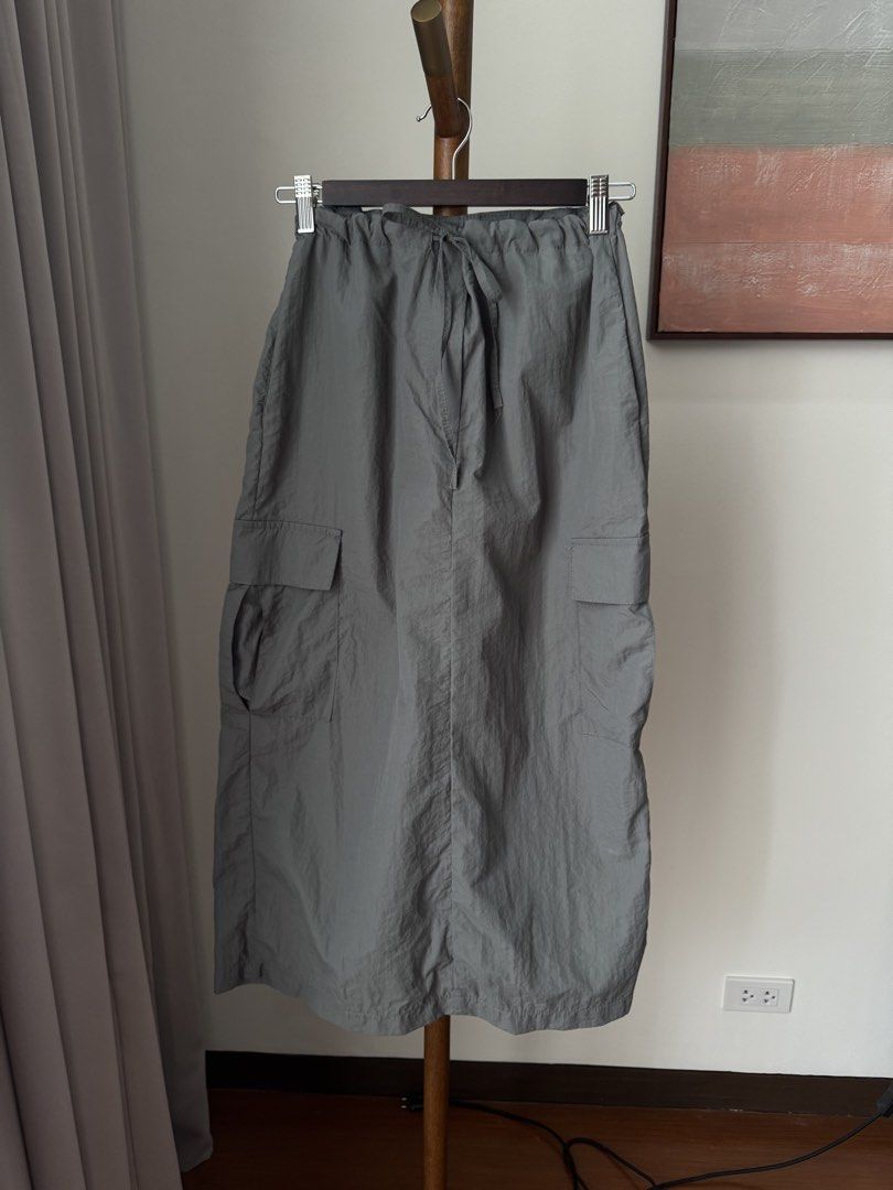 Grey Utility Cargo Maxi Skirt with Drawstring (Category: Skirts) located in Pasig City. Submitted by kutleyn (Listing ID 1465697222, Image 1). Description: - Color: Grey - Style: Utility cargo maxi skirt with straight cut - Material: Lightweight, easy-to-move crinkled nylon fabric - Fit: Comfortable elastic waistband with matching drawstring tie - Storage: Big cargo pockets on both sides - Length: Mid-calf - Condition: Brand new / Excellent (read