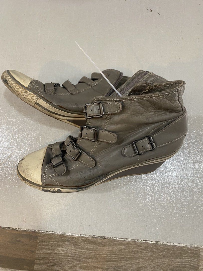 Grey Wedge Sneaker Boots with Buckles (Category: Boots) located in Alburquerque. Submitted by zanegavynn43872 (Listing ID 1465586245, Image 2). Description: - Item: Grey wedge sneaker boots - Size: 38 (marked on inner sole) - Features: Multiple strap and buckle details with convenient side zipper closure - Design: Wedge heel with contrasting white rubber toe caps - Condition: Worn condition with visible dirt marks and scuffs on soles and toes.