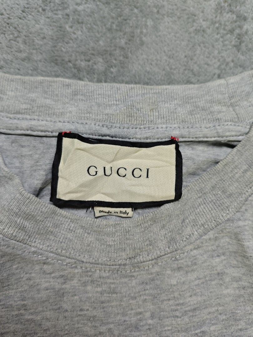 Gucci Arch Logo Light Gray Tee (Category: Tshirts & Polo Shirts ) located in San Pedro. Submitted by chronothrift (Listing ID 1465652644, Image 3). Description: - Size: Large - XL (W21.5 x 29L) - Condition: 9/10 - Color Rate: 9/10 - Flaws: Stains (Needs Wash) MOD: J&T Express / Lalamove / Meet MOP: Gcash / Bank Transfer.