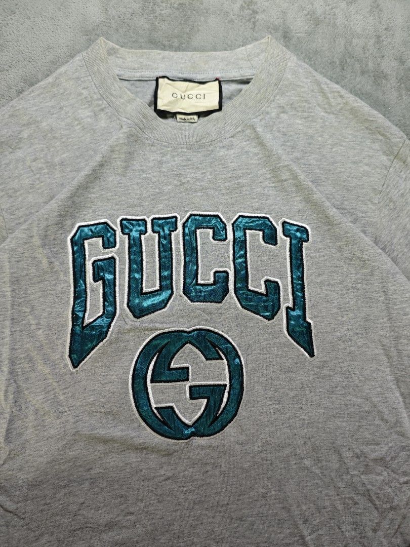 Gucci Arch Logo Light Gray Tee (Category: Tshirts & Polo Shirts ) located in San Pedro. Submitted by chronothrift (Listing ID 1465652644, Image 2). Description: - Size: Large - XL (W21.5 x 29L) - Condition: 9/10 - Color Rate: 9/10 - Flaws: Stains (Needs Wash) MOD: J&T Express / Lalamove / Meet MOP: Gcash / Bank Transfer.