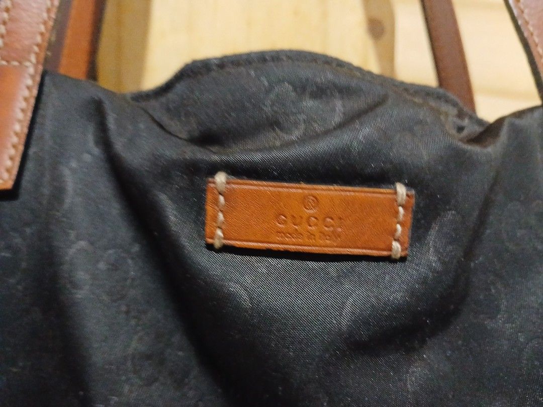 Gucci Black Monogram Nylon Tote Bag (Category: Luxury Bags & Wallets) located in Quezon City. Submitted by mcenon35 (Listing ID 1465655023, Image 2). Description: - Material: Durable black nylon with cream canvas lining - Design: Iconic all-over monogram pattern with brown leather handles and matching interior logo patch - Storage: Spacious daily carryall featuring a secure zipper pocket and open compartments - Condition: Clean interior with only