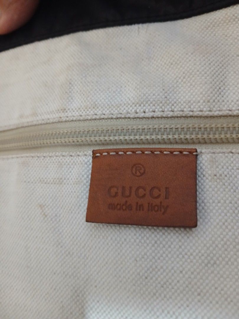 Gucci Black Monogram Nylon Tote Bag (Category: Luxury Bags & Wallets) located in Quezon City. Submitted by mcenon35 (Listing ID 1465655023, Image 3). Description: - Material: Durable black nylon with cream canvas lining - Design: Iconic all-over monogram pattern with brown leather handles and matching interior logo patch - Storage: Spacious daily carryall featuring a secure zipper pocket and open compartments - Condition: Clean interior with only