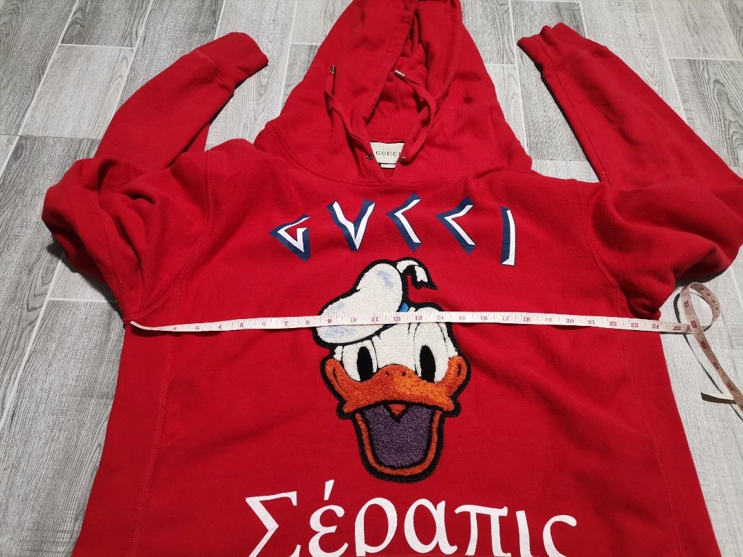 Gucci x Disney Distressed (Category: Others Tops) located in Iba. Submitted by selector_items (Listing ID 1465642042, Image 3). Description: *Gucci x Disney "Distressed" Donald Duck Hoodie* from the 2020 Pre-Fall Collection 🔥 ### *What makes it "distressed":* 1. *Design intent* - Gucci intentionally made this with a worn/vintage effect. That slight fraying near the hood drawstring and the textured chenille patch are part of the look. 2. *Chenill
