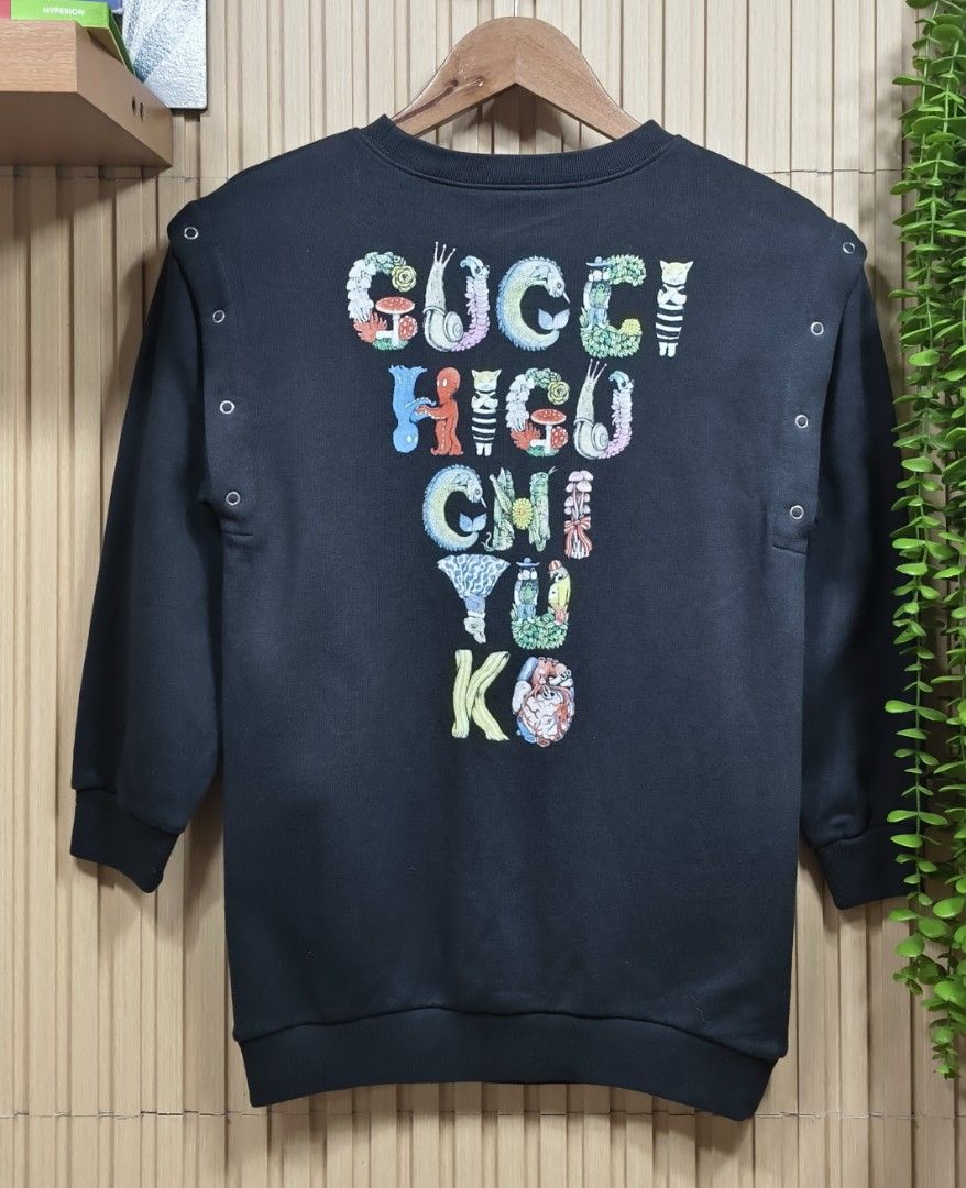 Gucci x Yuko Higuchi 2-Way Sweatshirt (Category: Babies & Kids Fashion) located in Quezon City. Submitted by christinejoycheng1 (Listing ID 1465736294, Image 2). Description: - Brand: Gucci x Yuko Higuchi - Size: Kids 8 - Design: Cute cat, mushroom, and flower graphic on the front; collaboration logo on the back - Versatile 2-way style: Metal snap buttons on the shoulders allow you to remove sleeves and convert it into a sleeveless top - Care: Ha