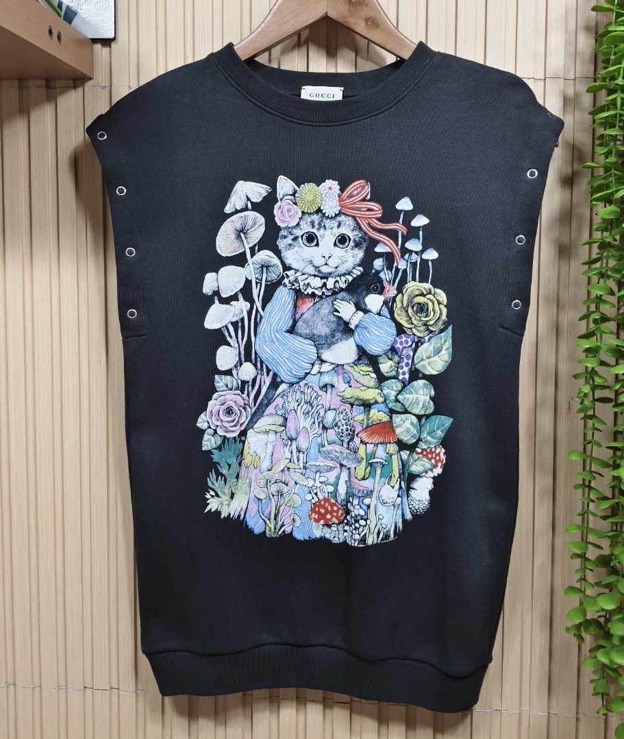Gucci x Yuko Higuchi 2-Way Sweatshirt (Category: Babies & Kids Fashion) located in Quezon City. Submitted by christinejoycheng1 (Listing ID 1465736294, Image 3). Description: - Brand: Gucci x Yuko Higuchi - Size: Kids 8 - Design: Cute cat, mushroom, and flower graphic on the front; collaboration logo on the back - Versatile 2-way style: Metal snap buttons on the shoulders allow you to remove sleeves and convert it into a sleeveless top - Care: Ha