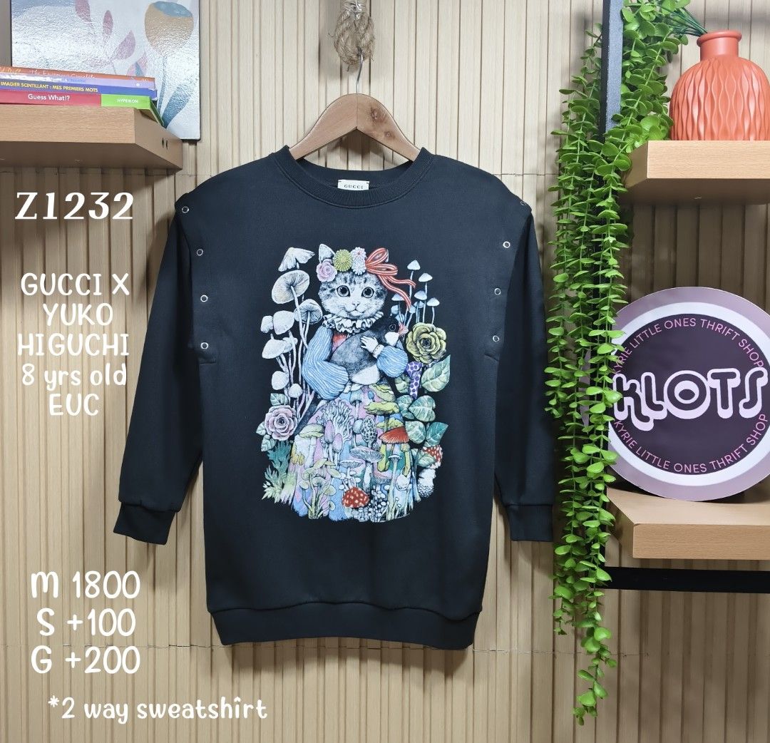 Gucci x Yuko Higuchi 2-Way Sweatshirt (Category: Babies & Kids Fashion) located in Quezon City. Submitted by christinejoycheng1 (Listing ID 1465736294, Image 1). Description: - Brand: Gucci x Yuko Higuchi - Size: Kids 8 - Design: Cute cat, mushroom, and flower graphic on the front; collaboration logo on the back - Versatile 2-way style: Metal snap buttons on the shoulders allow you to remove sleeves and convert it into a sleeveless top - Care: Ha