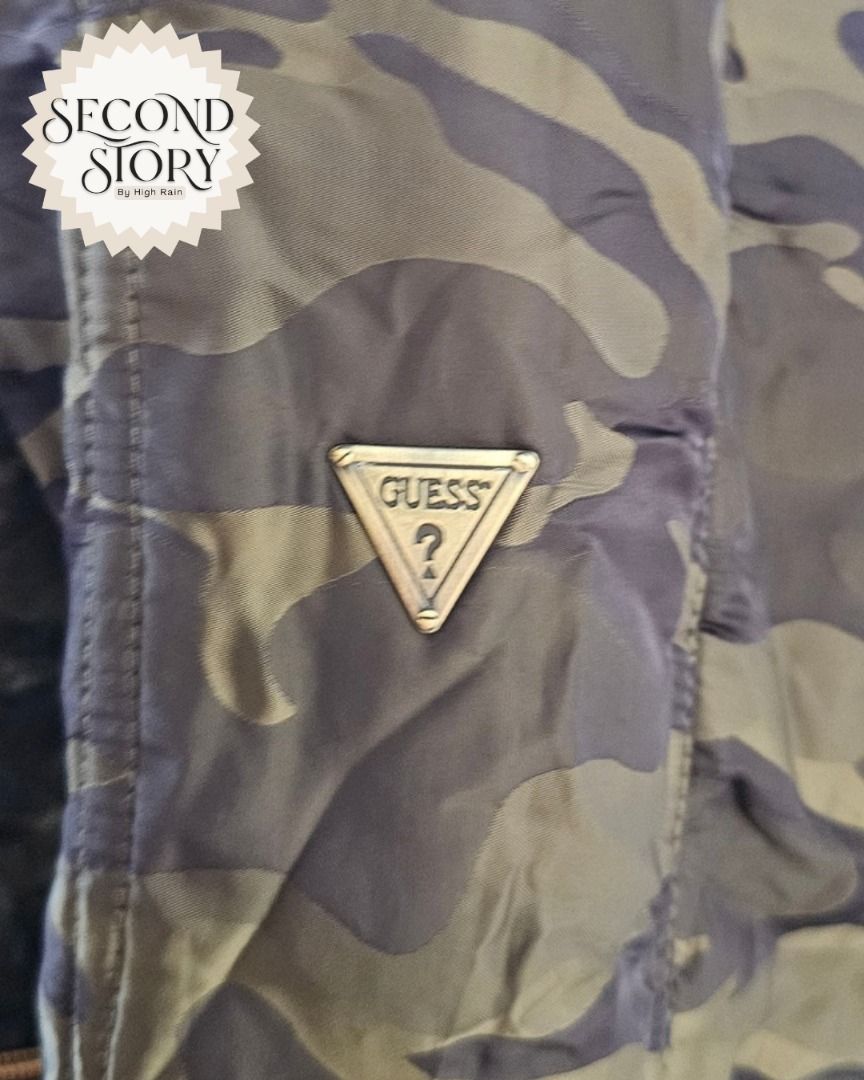 Guess Camouflage Puffer Jacket (Category: Coats, Jackets and Outerwear) located in Cavite. Submitted by secondstorybyhighrain (Listing ID 1465598778, Image 3). Description: - Brand: Guess - Color/Pattern: Green camouflage - Details: Metal triangle logo badge on chest, full zip front closure - Material/Feature: Quilted fabric for extra warmth - Style: Great casual winter layer B 38 L 22.
