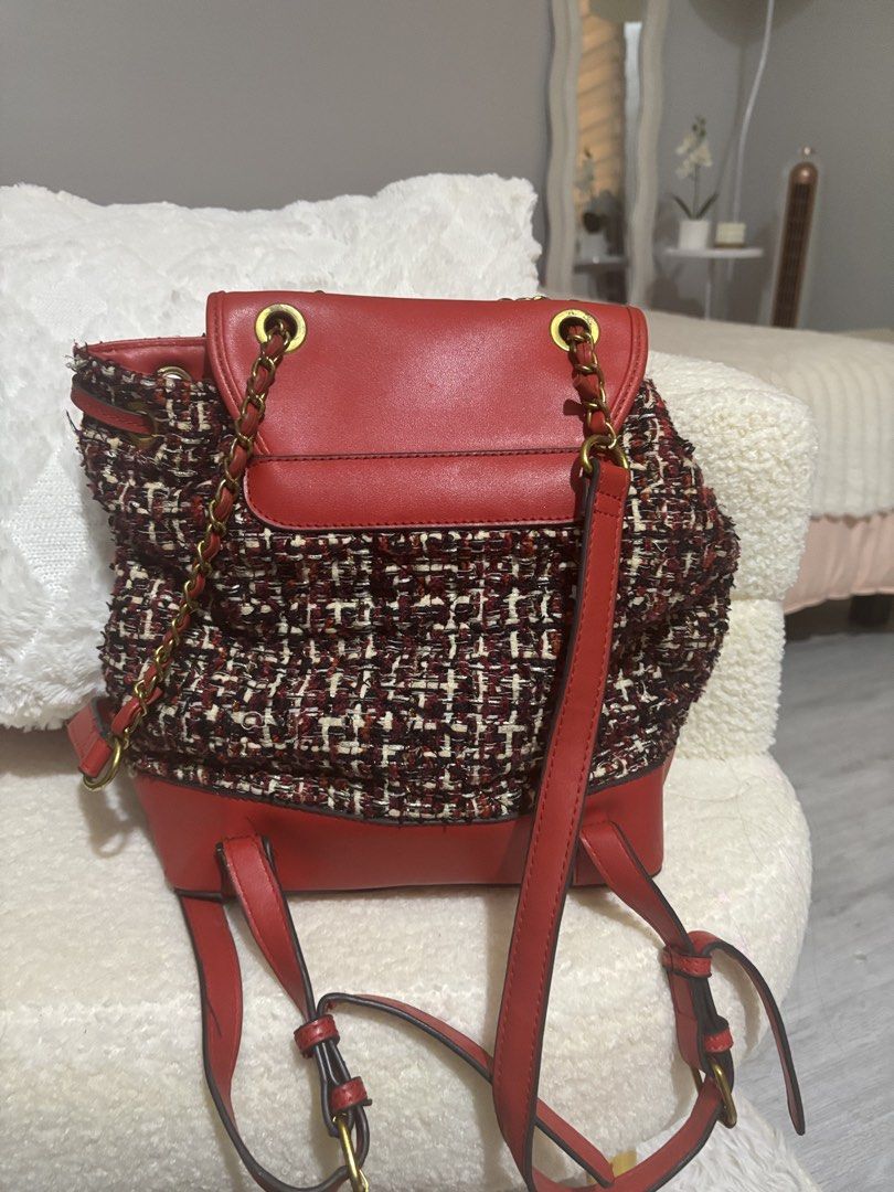 Guess Tweed and Red Leather Backpack (Category: Backpacks) located in Quezon City. Submitted by hadescloset (Listing ID 1465658135, Image 2). Description: - Brand: Guess - Material: Red faux leather & multi-colored tweed fabric - Hardware: Elegant gold-tone chain accents - Closure: Front flap with magnetic snap & secure inner drawstring - Straps: Adjustable shoulder straps for comfort - Base & Interior: Structured red leather base with deep red i