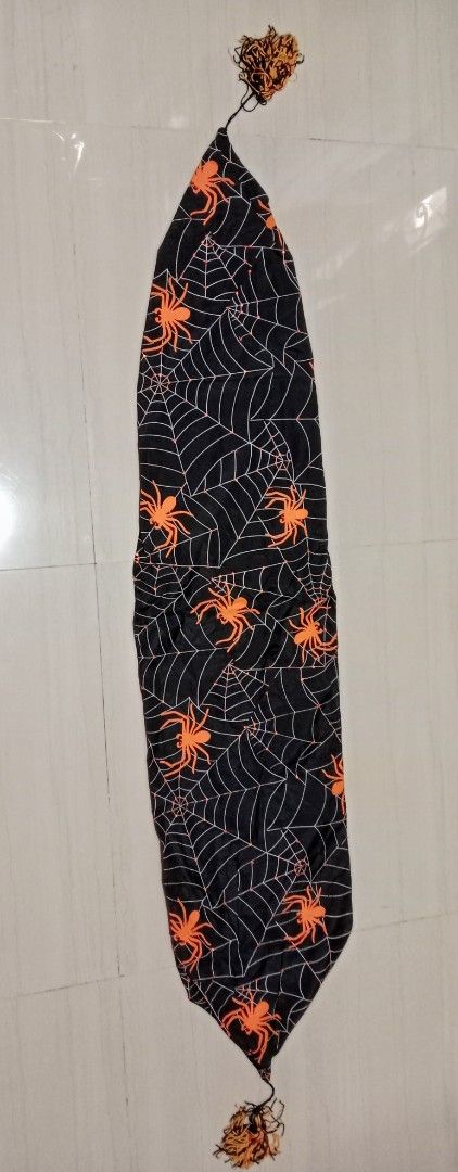 Halloween Spider Web Table Runner with Tassels (Category: Table Linen & Textiles) located in Mangaldan. Submitted by closetqwin (Listing ID 1465635744, Image 2). Description: 55 inches Length -Black with orange spider - Details: Pointed ends finished with black and orange tassels.