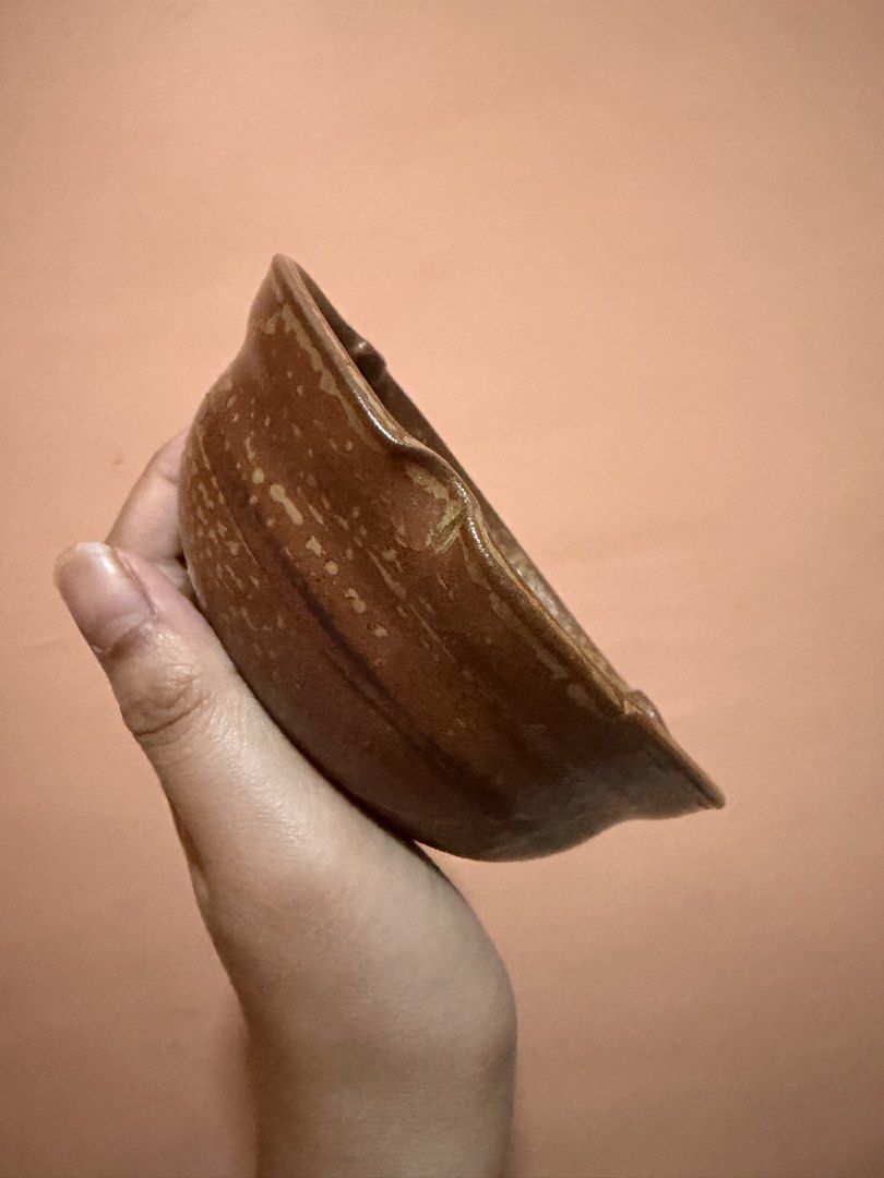 Handmade brown speckled ceramic bowl pottery (Category: Vases & Decorative Bowls) located in Manila. Submitted by renkacoleni (Listing ID 1465705077, Image 2). Description: - Material: Earth-toned ceramic with a textured speckled glaze - Design: Distinctive notched rim details on opposite sides - Finish: Deep interior with a smooth, glossy finish - Style: Sturdy base with a charming handmade look - Color: Rich earthy brown.