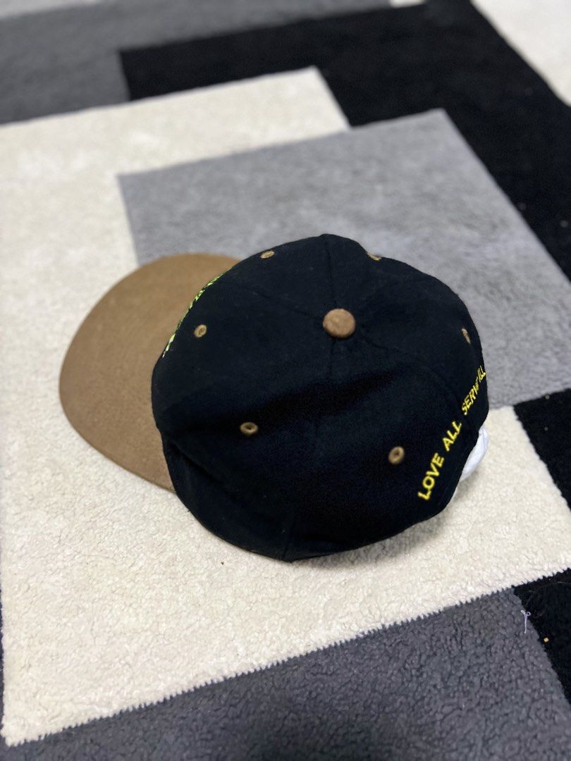 Hard Rock Cafe Guangzhou Save The Planet Cap (Category: Caps & Hats) located in Calasiao. Submitted by pb.supply_v2 (Listing ID 1465752640, Image 3). Description: - Brand: Hard Rock Cafe Guangzhou - Design: Black body with a contrasting brown brim - Embroidery: 'Save The Planet' and 'Guangzhou' on the front; 'Love All Serve All' in yellow on the back - Fit: Adjustable plastic snap closure - Condition: Excellent, ready to wear.