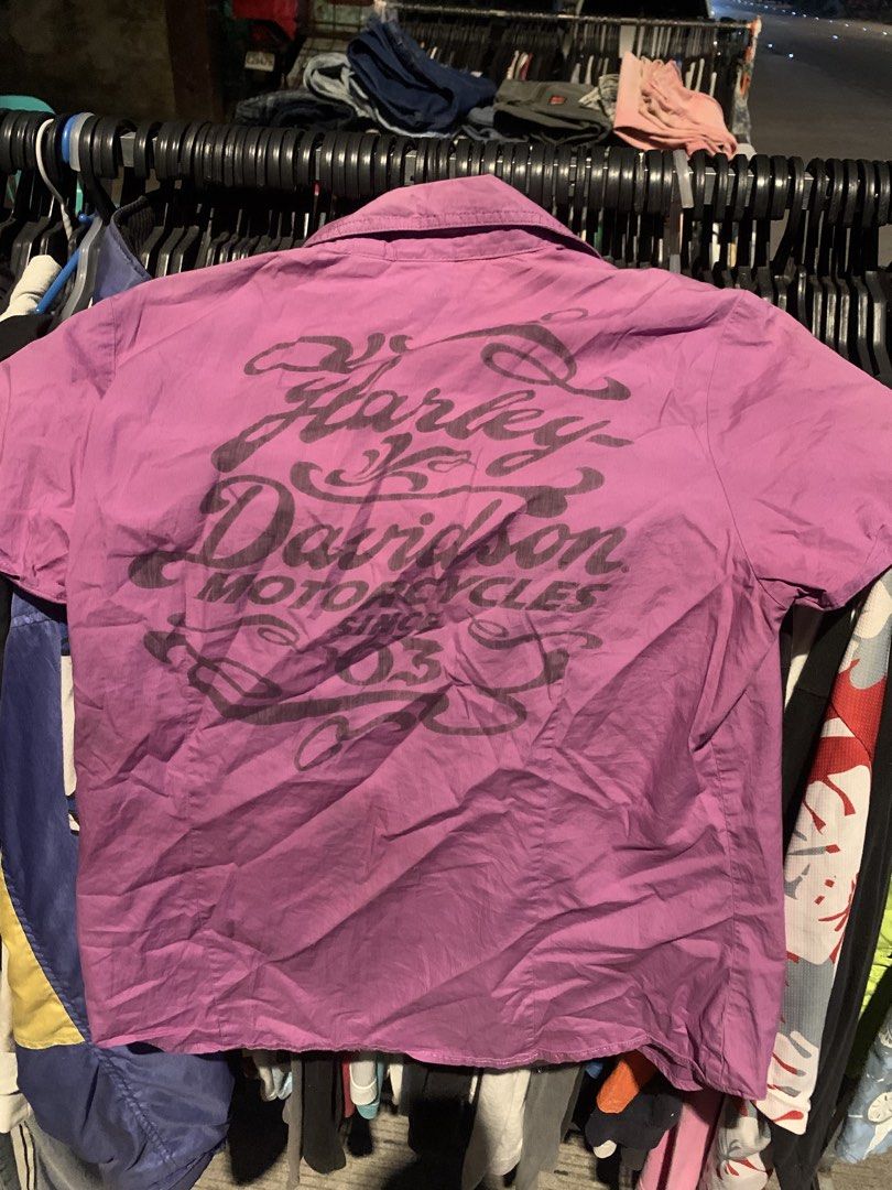 Harley-Davidson Purple Short Sleeve Button Down Shirt (Category: Tshirts & Polo Shirts ) located in Naga. Submitted by than09070539101 (Listing ID 1465748692, Image 2). Description: - Brand: Harley-Davidson - Style: Short sleeve button-down shirt - Size: Medium (collar tag attached) - Color: Purple - Details: Front chest pockets with button closures, sparkling rhinestone accent buttons - Back Design: Large iconic Harley-Davidson motorcycles graph