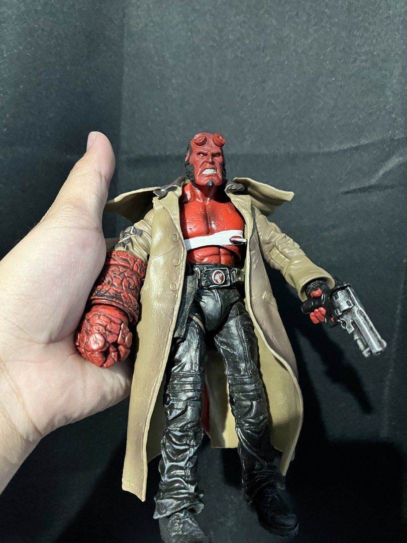 Hellboy Action Figure with Trench Coat and Gun (Category: Figurines & Statues) located in Cabanatuan. Submitted by isaiahave (Listing ID 1465678801, Image 2). Description: - Detailed Hellboy action figure holding his signature Samaritan gun - Features the iconic Right Hand of Doom and a classic tan trench coat - Accurately sculpted with black pants, textured boots, and visible red tail at the back - Stands upright firmly, perfect for display - Gr