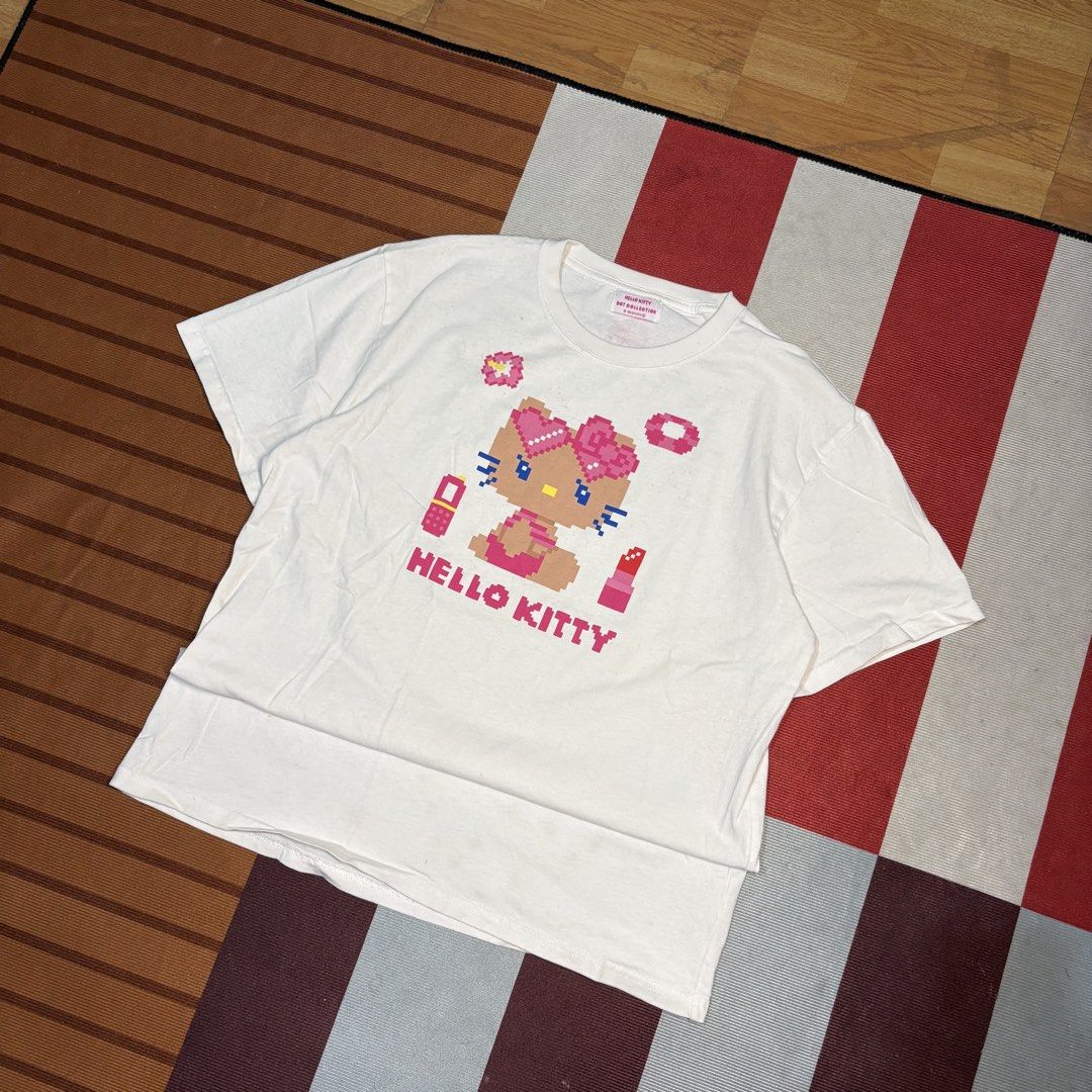 Hello Kitty Pixel Collection White T-Shirt (Category: Shirts) located in Manila. Submitted by carlmachu (Listing ID 1465703969, Image 1). Description: - Authentic Sanrio Kitty graphic tee from the Dot Collection - Features a cute pixel art print with accessories (phone, lipstick, ring) - Color: White - Material: Soft, comfortable cotton - Design: Short sleeves, crew neck - Condition: Excellent, clean with no stains or holes - Perfect for casual, 