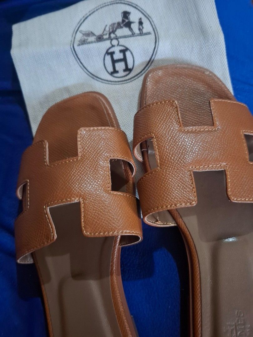 Hermes Oran Sandals Tan Size 35 (Category: Flats & Sandals) located in Marikina City. Submitted by bags21.ph (Listing ID 1465584397, Image 3). Description: - Authentic Hermes Oran Slide Sandals - Color: Classic Tan - Size: 35 EU - Material: Premium leather upper and sole - Design: Iconic H-cut strap, stamped Hermes Paris on inner sole and outsole - Origin: Made in Italy - Inclusion: Original dust bag with Hermes horse and carriage logo - Conditio