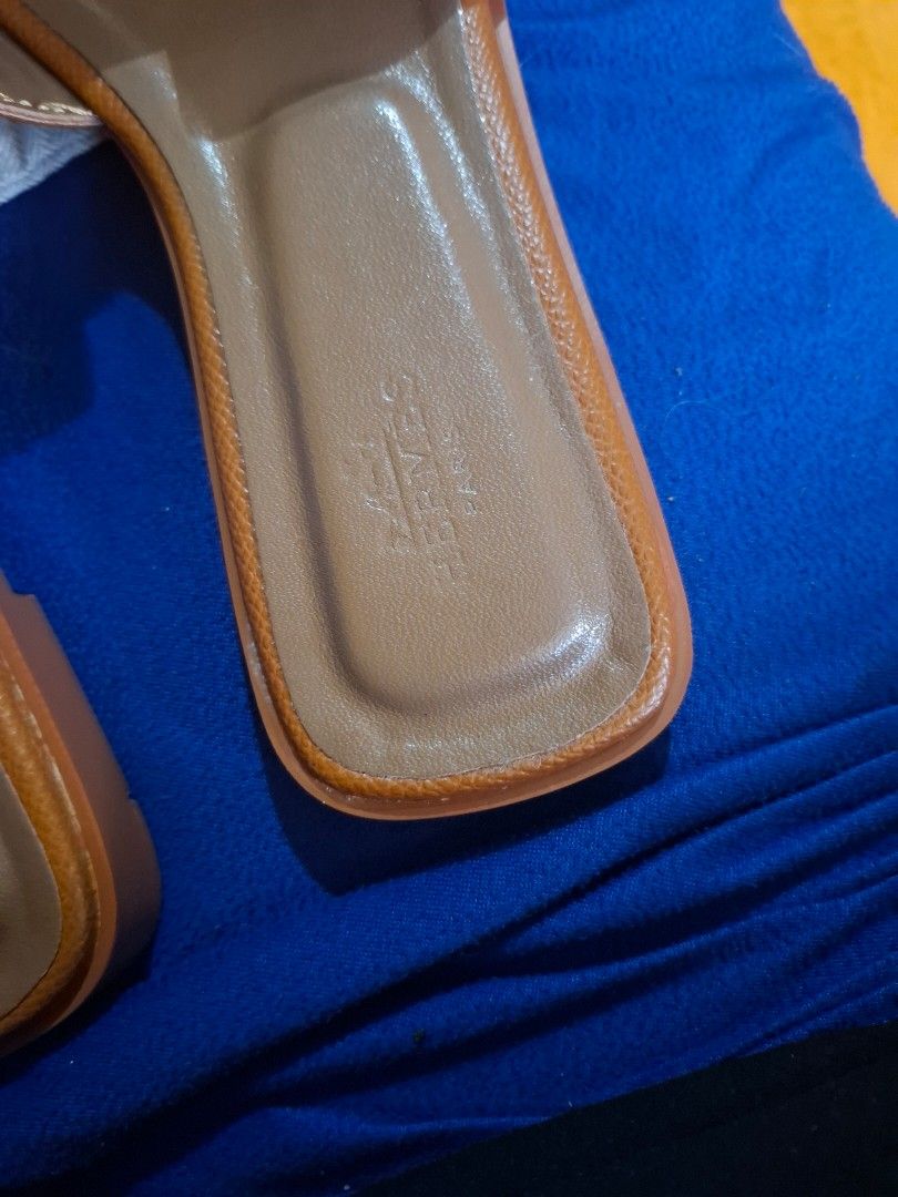 Hermes Oran Sandals Tan Size 35 (Category: Flats & Sandals) located in Marikina City. Submitted by bags21.ph (Listing ID 1465584397, Image 2). Description: - Authentic Hermes Oran Slide Sandals - Color: Classic Tan - Size: 35 EU - Material: Premium leather upper and sole - Design: Iconic H-cut strap, stamped Hermes Paris on inner sole and outsole - Origin: Made in Italy - Inclusion: Original dust bag with Hermes horse and carriage logo - Conditio