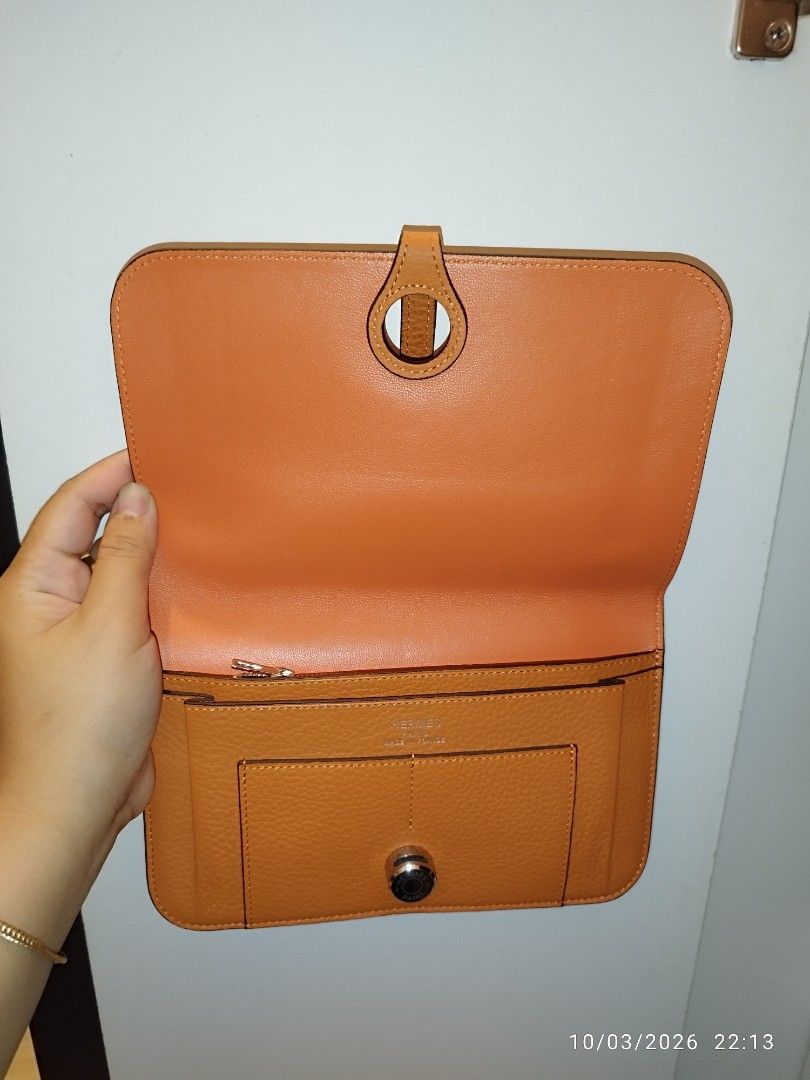 Hermès Orange Leather Wallet (Category: Wallets & Card holders) located in Cebu City. Submitted by jlorana11395954 (Listing ID 1465717888, Image 2). Description: - Brand: Hermès - Color: Iconic Hermès Orange - Material: Premium leather with clean stitching - Closure: Distinctive front flap clasp - Interior: Zippered compartment and multiple card slots - Bonus: Includes a matching removable zipped pouch insert - Design: Compact size, easy to slip 