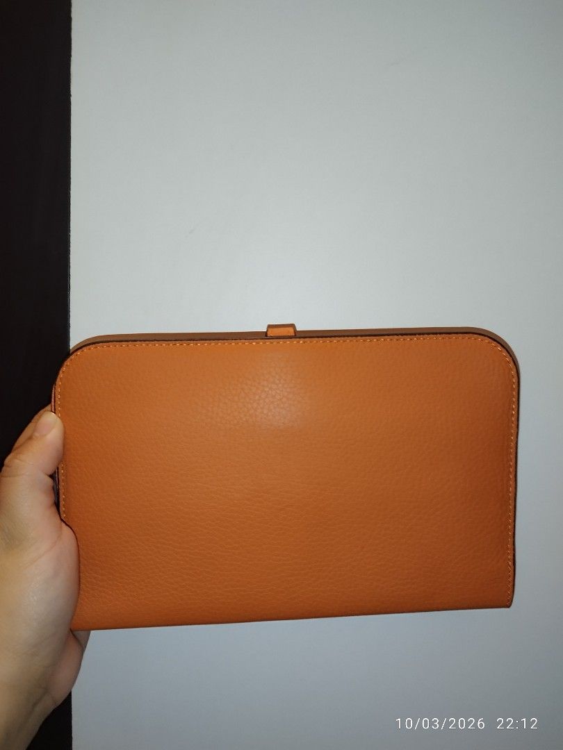 Hermès Orange Leather Wallet (Category: Wallets & Card holders) located in Cebu City. Submitted by jlorana11395954 (Listing ID 1465717888, Image 3). Description: - Brand: Hermès - Color: Iconic Hermès Orange - Material: Premium leather with clean stitching - Closure: Distinctive front flap clasp - Interior: Zippered compartment and multiple card slots - Bonus: Includes a matching removable zipped pouch insert - Design: Compact size, easy to slip 